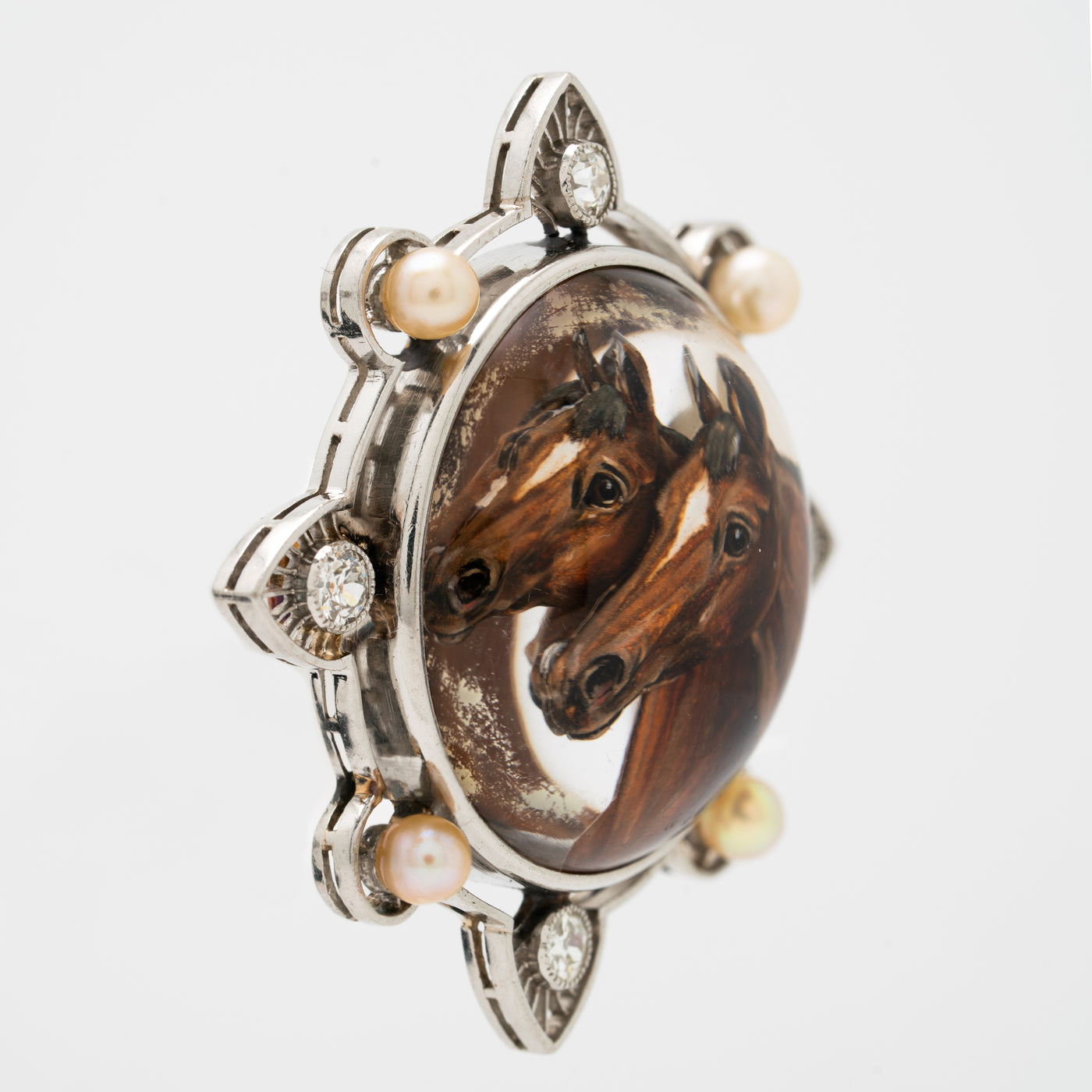 EDWARDIAN PLATINUM, DIAMOND AND PEARL REVERSED CARVED EQUESTRIAN BROOCH c.1910