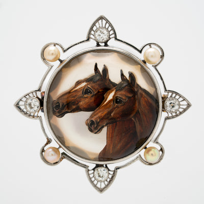 EDWARDIAN PLATINUM, DIAMOND AND PEARL REVERSED CARVED EQUESTRIAN BROOCH c.1910
