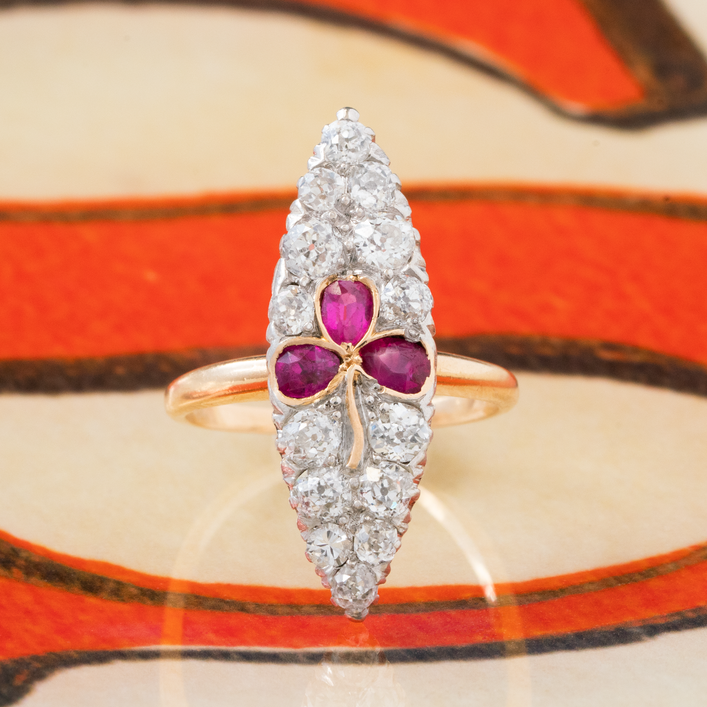 VICTORIAN 18K YELLOW GOLD, SILVER AND 1.15CTS. OLD EUROPEAN CUT DIAMONDS AND NATURAL RUBIES TREFOIL NAVETTE RING c.1880s